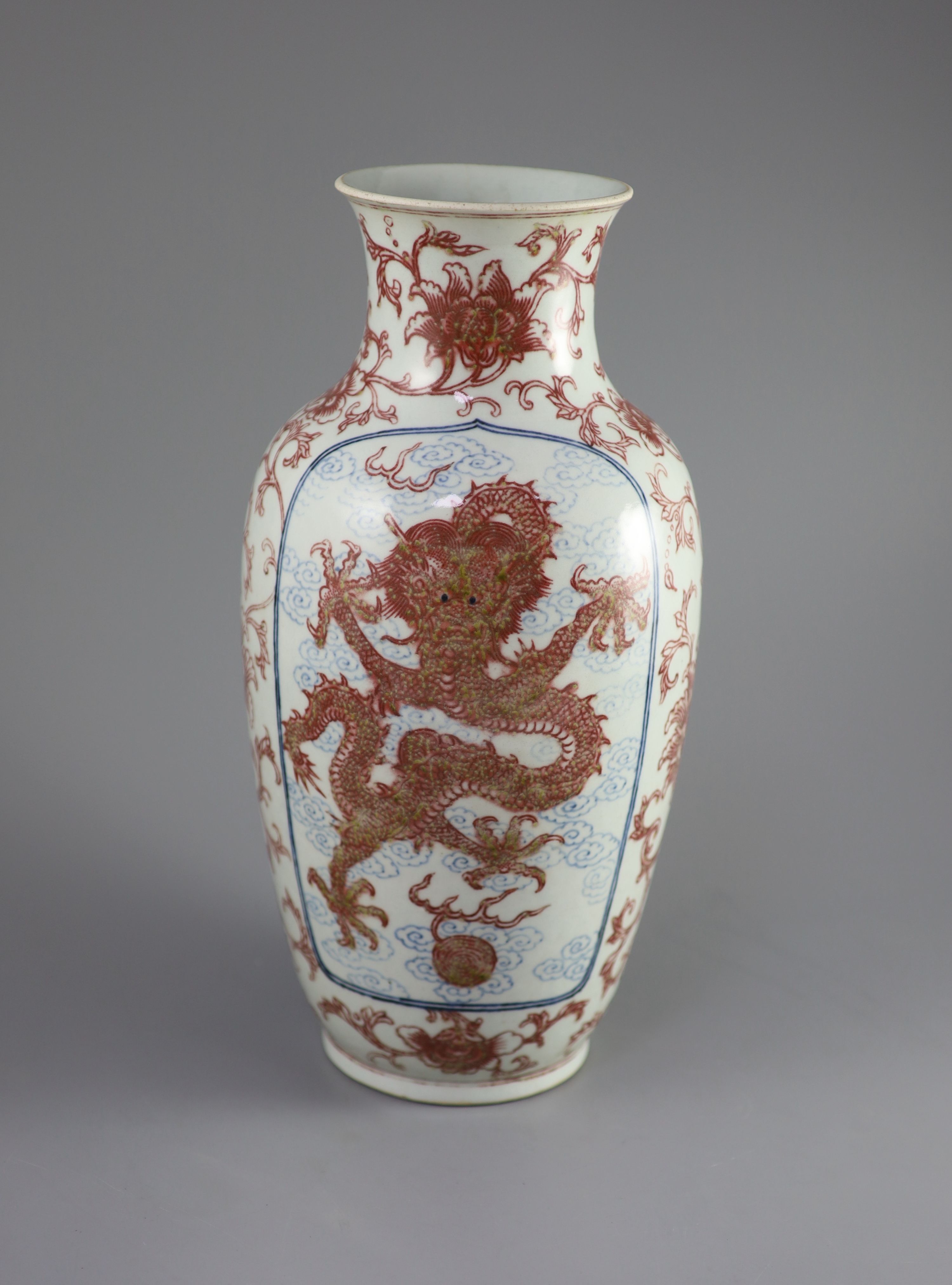 A Chinese underglaze blue and copper red 'dragon and phoenix' vase, Daoguang period (1821-50), 36cm high, rim ground off